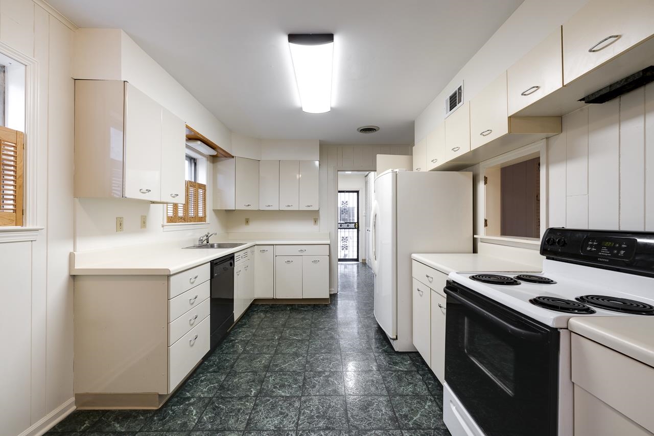 5673 Normandy Road Memphis, TN 38120 - Photo 18 of 39 a kitchen with a stove a sink and a refrigerator