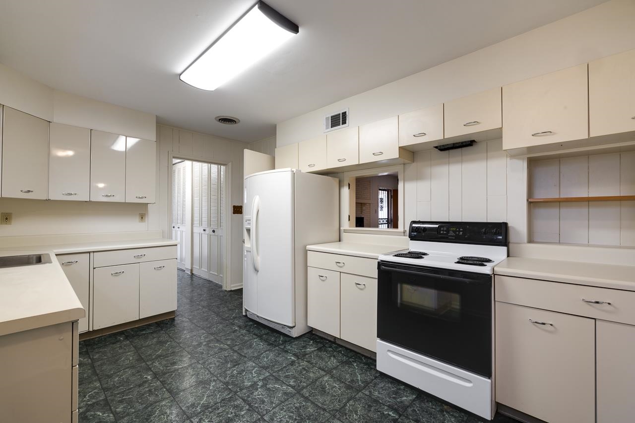 5673 Normandy Road Memphis, TN 38120 - Photo 19 of 39 a kitchen with white cabinets and white appliances