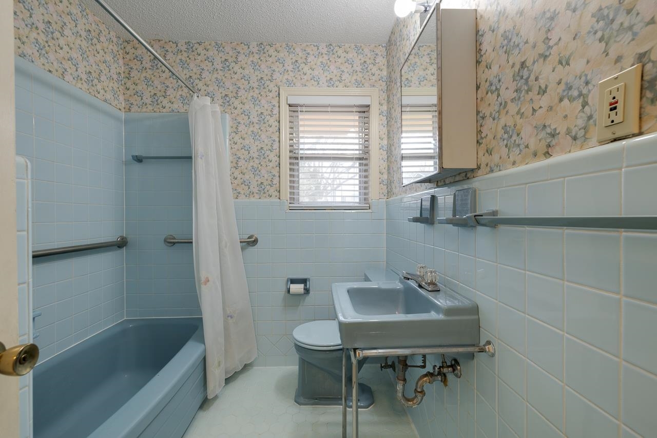 5673 Normandy Road Memphis, TN 38120 - Photo 23 of 39 a bathroom with a sink a toilet and shower