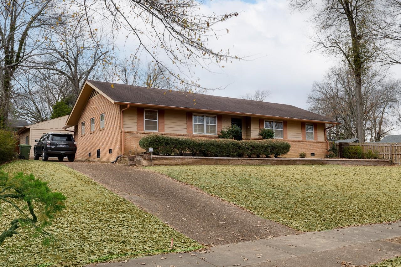 5673 Normandy Road Memphis, TN 38120 - Photo 4 of 39 a front view of a house with a yard and garage