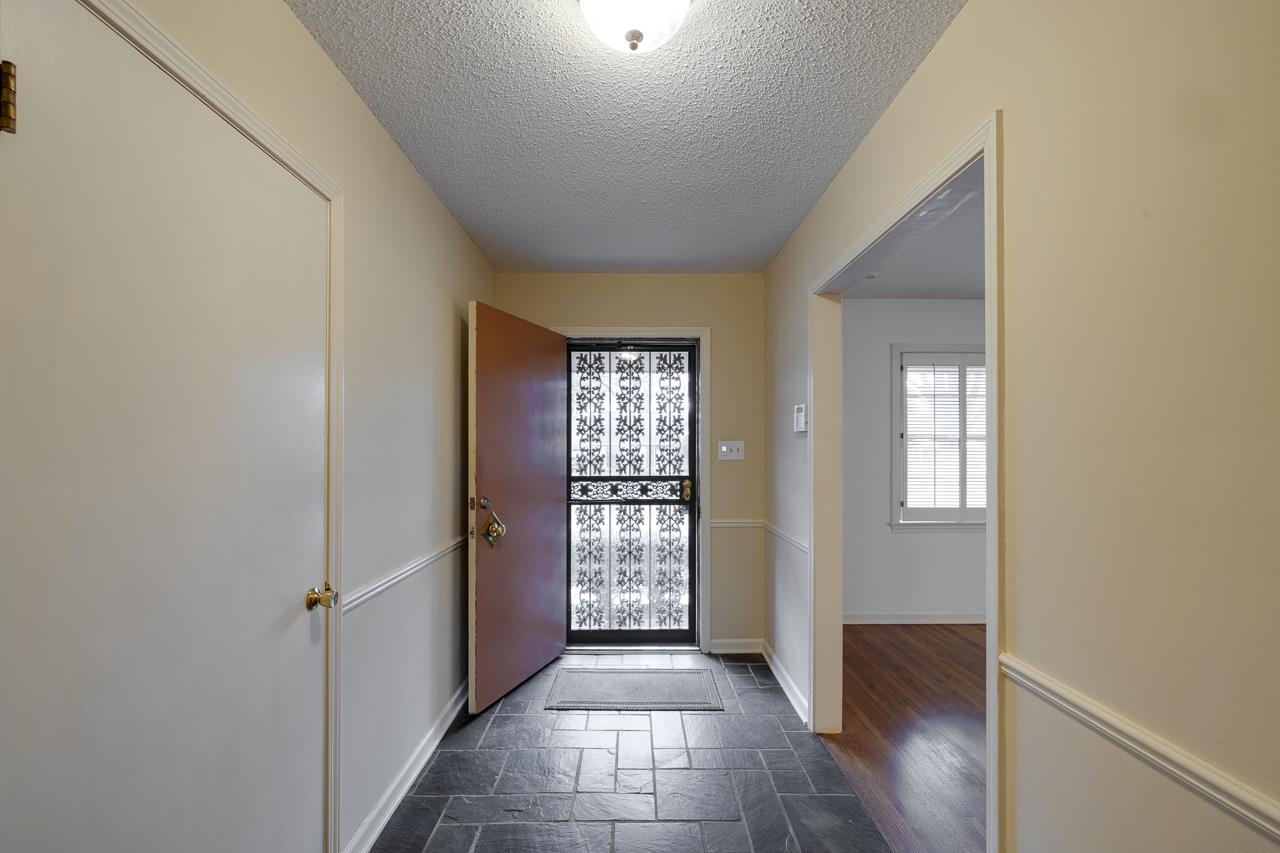 5673 Normandy Road Memphis, TN 38120 - Photo 6 of 39 a view of a hallway with wooden floor and windows
