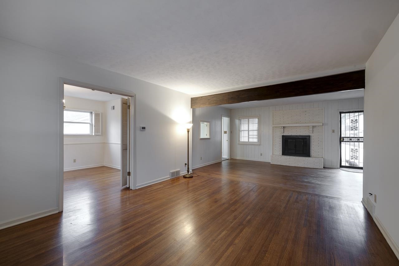5673 Normandy Road Memphis, TN 38120 - Photo 7 of 39 a view of an empty room with window and wooden floor