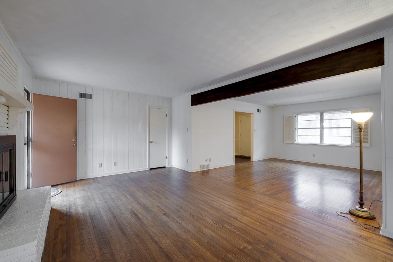 5673 Normandy Road Memphis, TN 38120 - Photo 10 of 39 a view of an empty room with window and wooden floor