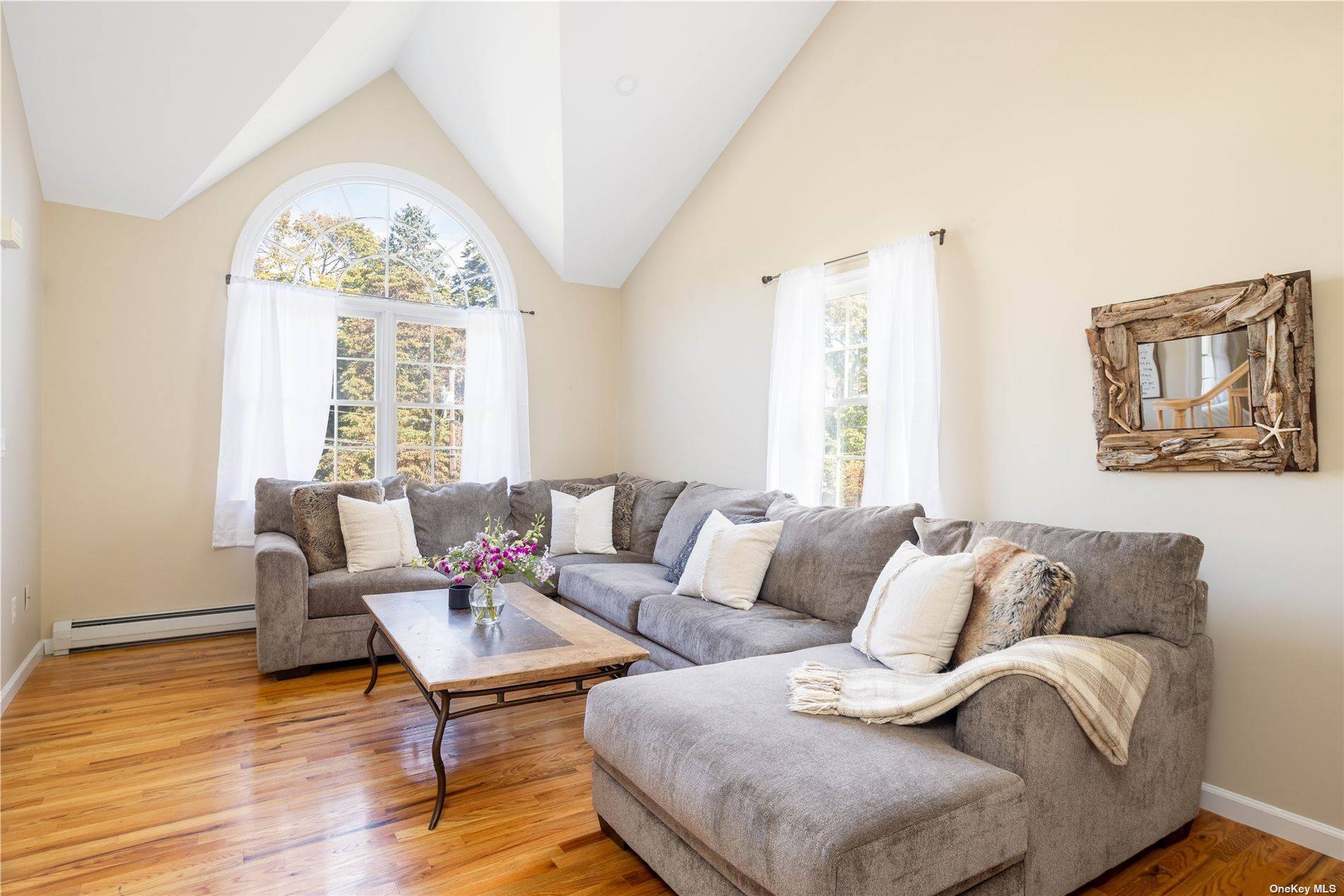 115 Cliff Road Wading River, NY 11792 - Photo 11 of 28 a living room with furniture and a large window