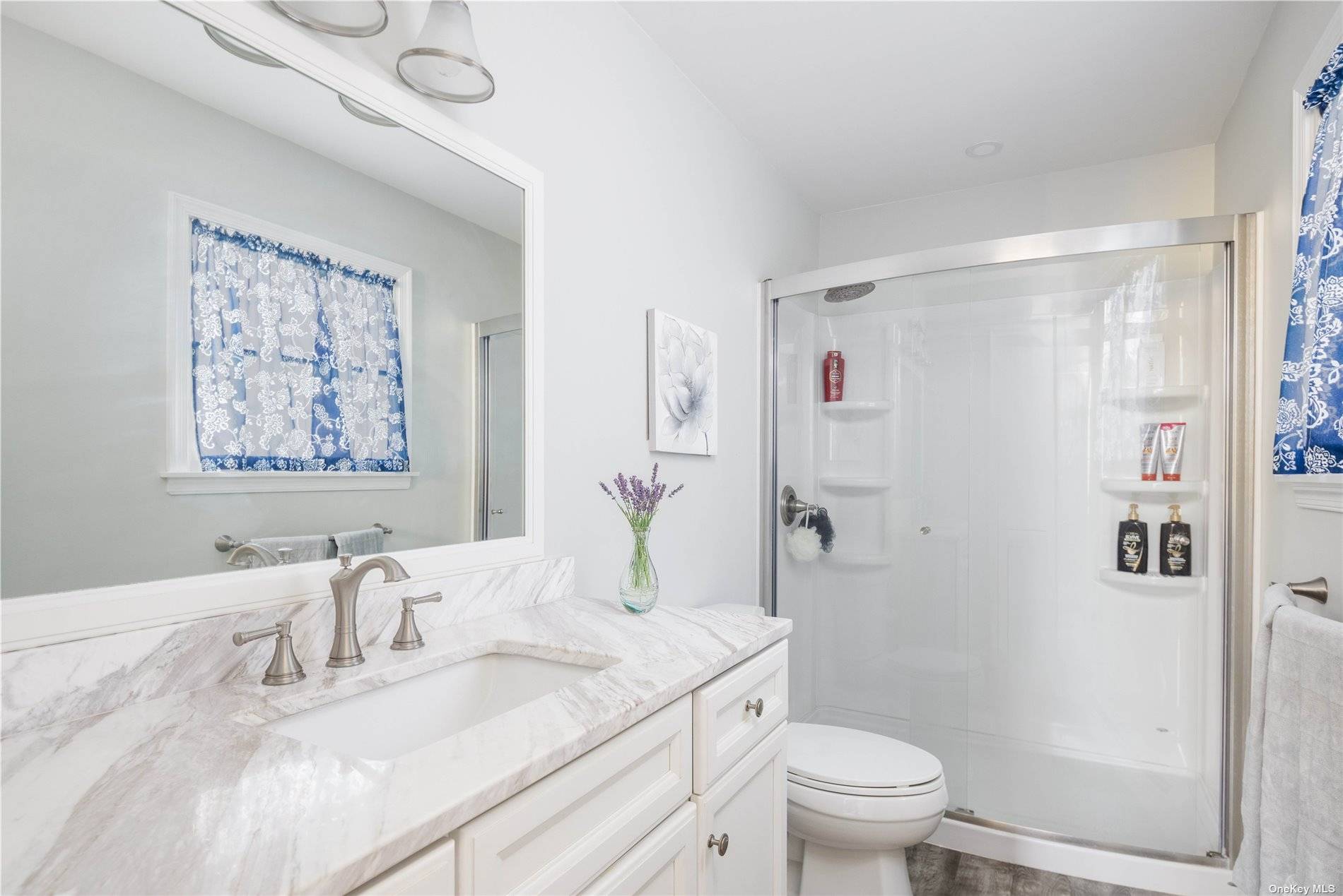 115 Cliff Road Wading River, NY 11792 - Photo 15 of 28 a bathroom with a granite countertop sink a toilet and a shower