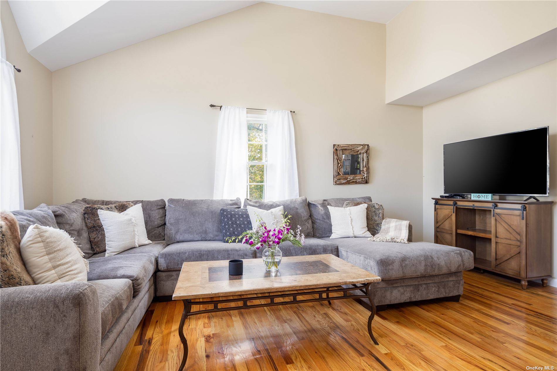 115 Cliff Road Wading River, NY 11792 - Photo 10 of 28 a living room with furniture and a flat screen tv