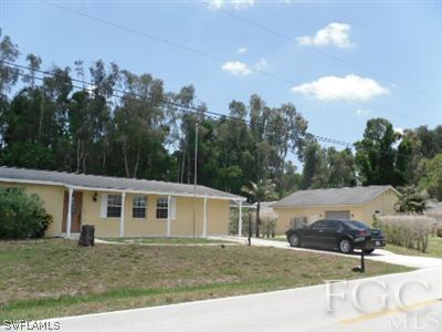 18453 Iris Road Fort Myers, FL 33967 - Photo 2 of 10 a view of a yard in front of a house with a garden