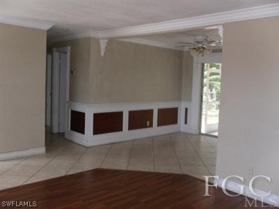 18453 Iris Road Fort Myers, FL 33967 - Photo 3 of 10 a view of an empty room with wooden floor and a window