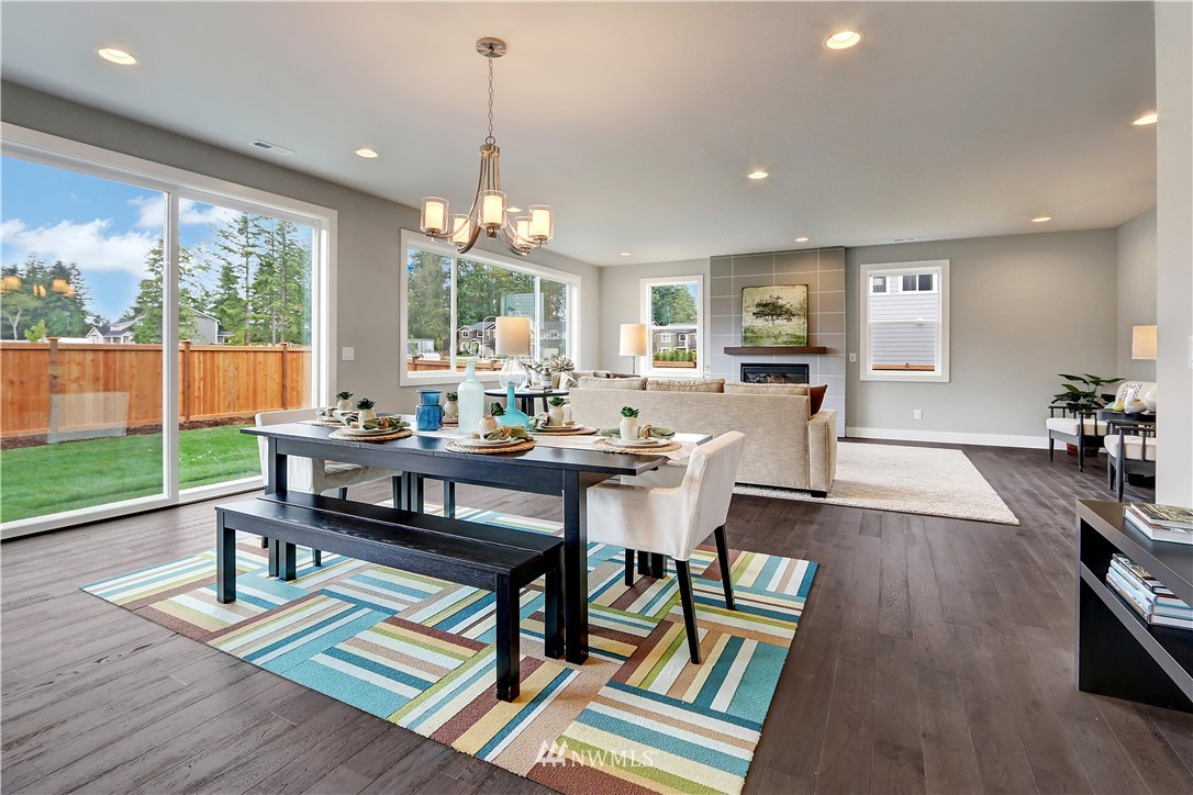 252 Field Place Southeast Renton, WA 98059 - Photo 3 of 21 a view of a dining room with furniture window and wooden floor