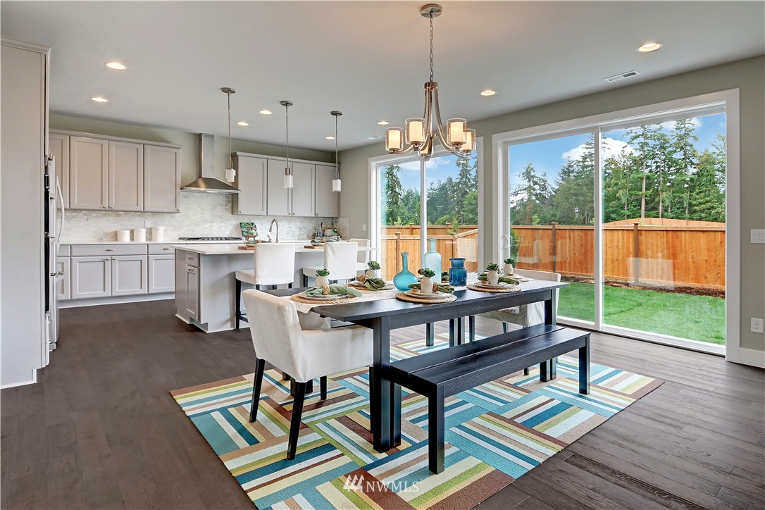 252 Field Place Southeast Renton, WA 98059 - Photo 5 of 21 a view of a dining room with furniture window and wooden floor