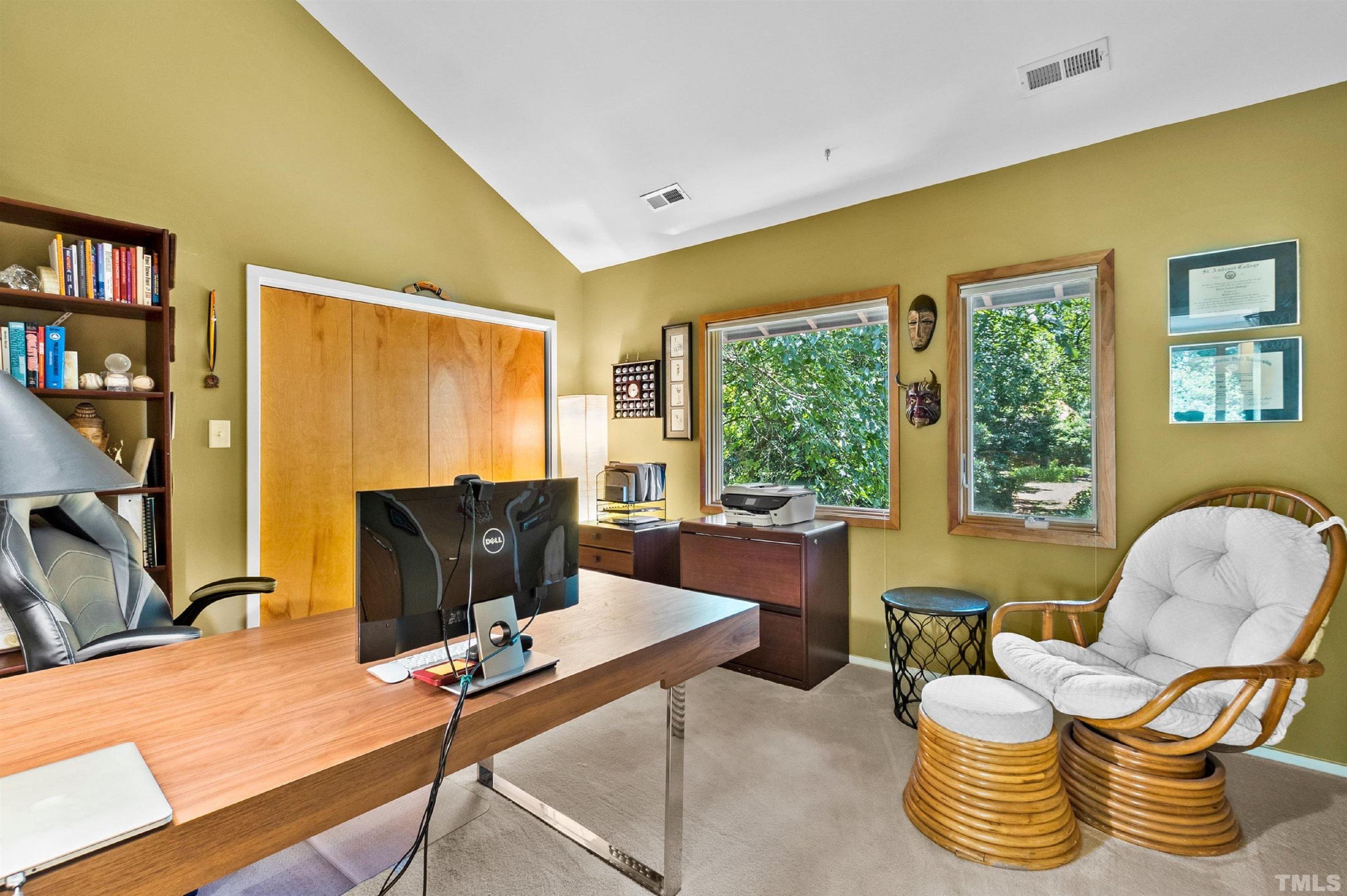 2700 Webb Street Raleigh, NC 27609 - Photo 46 of 60 a work room with furniture and a flat screen tv