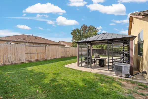 a view of a patio with table and chairs a barbeque with wooden fence