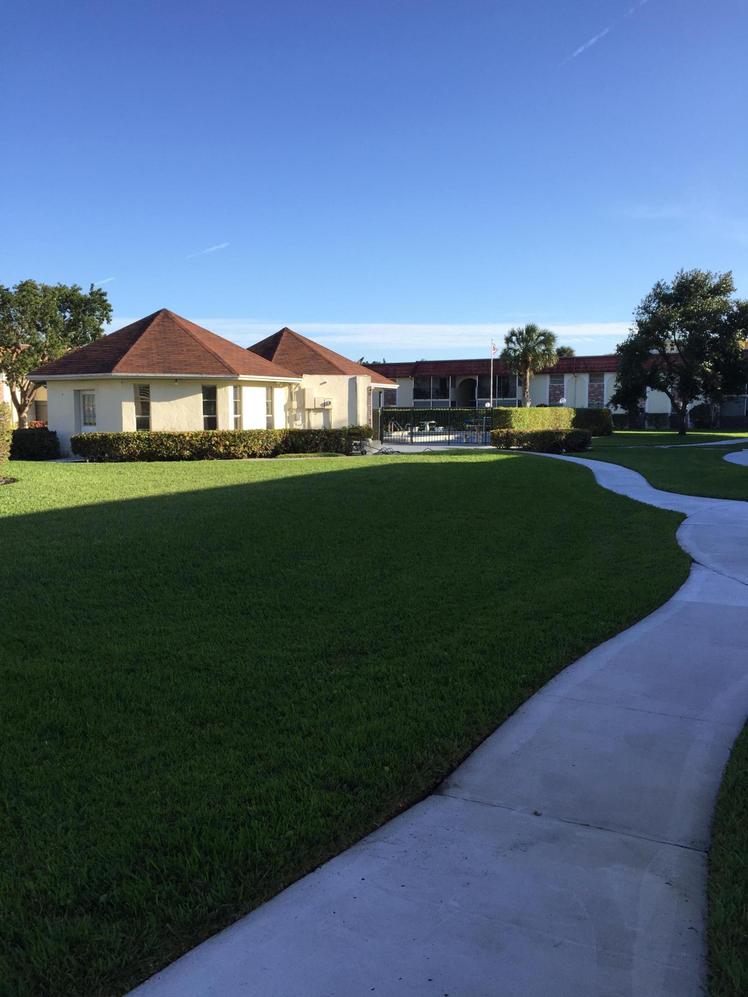 22735 Southwest 66th Avenue, Unit 105 Boca Raton, FL 33428 - Photo 25 of 25 a view of a big house with a big yard