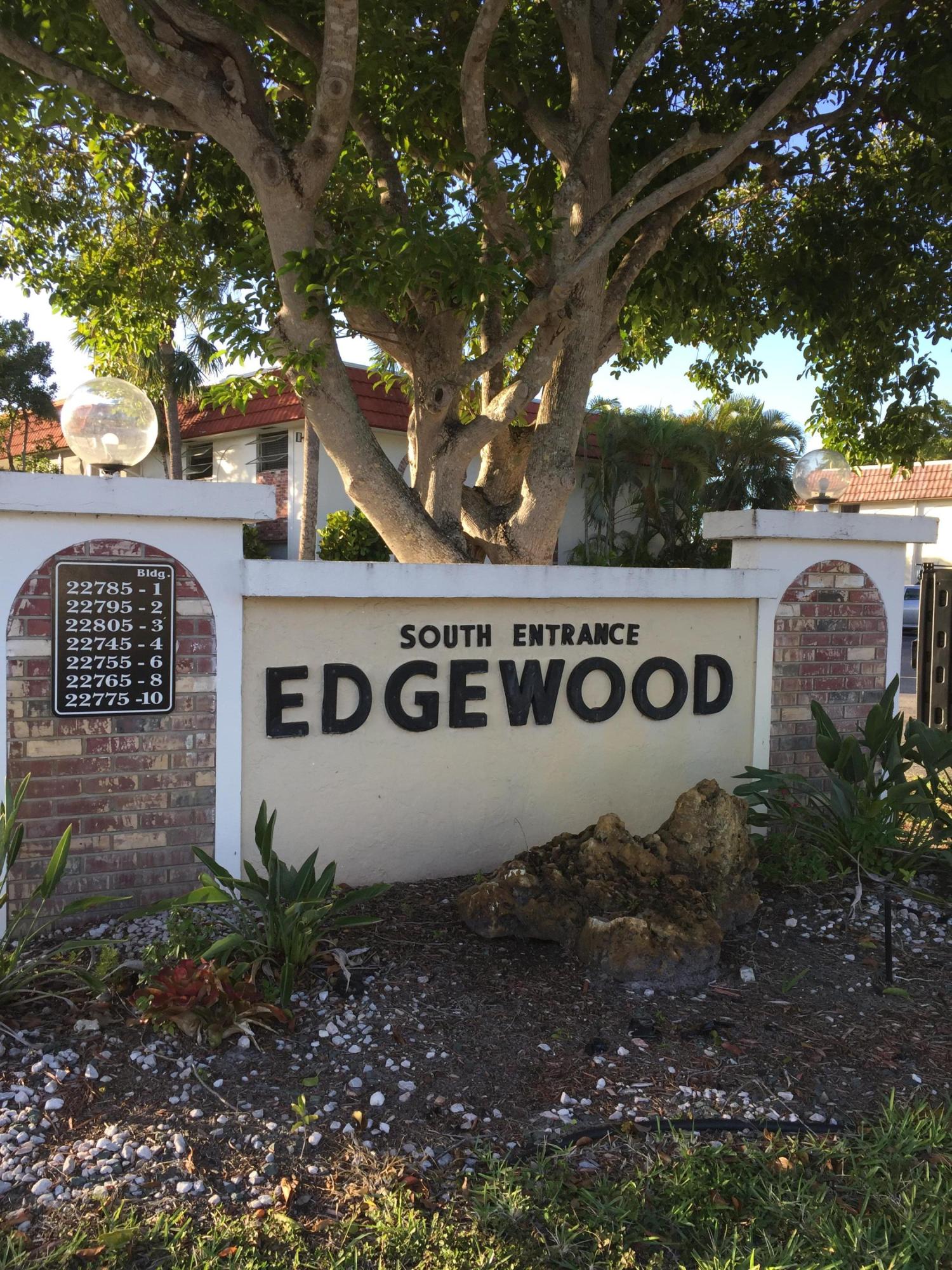 22735 Southwest 66th Avenue, Unit 105 Boca Raton, FL 33428 - Photo 3 of 25 a view of outdoor space with signage and flags