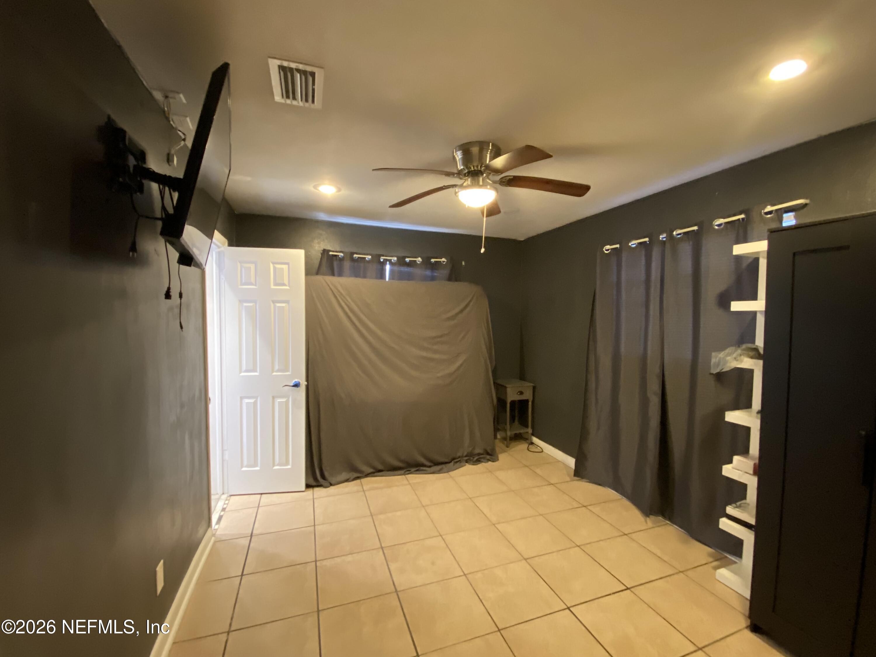 6400 Diane Road Jacksonville, FL 32277 - Photo 11 of 16 a bathroom with a mirror and a shower