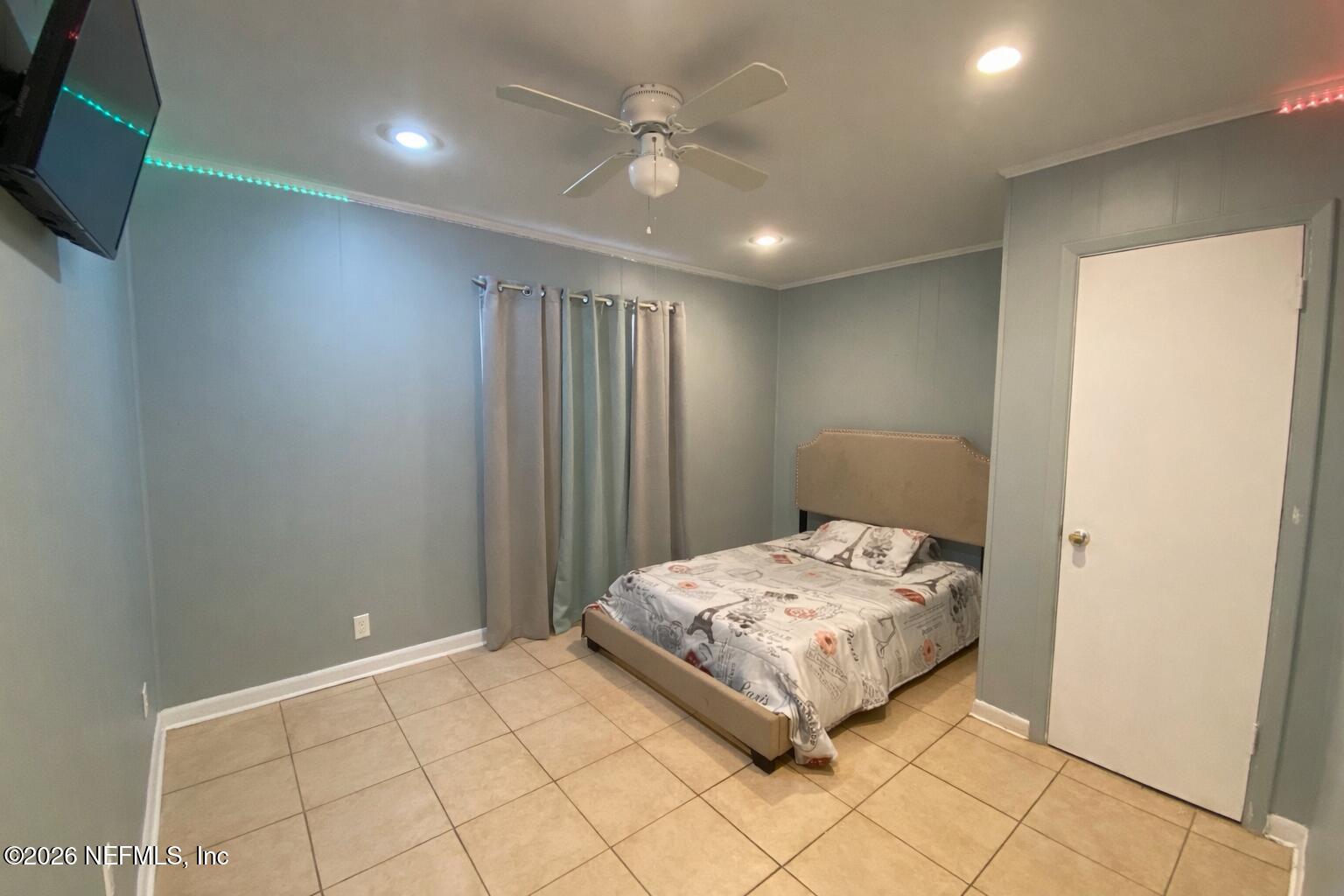 6400 Diane Road Jacksonville, FL 32277 - Photo 13 of 16 a bedroom with a bed and a wall painting