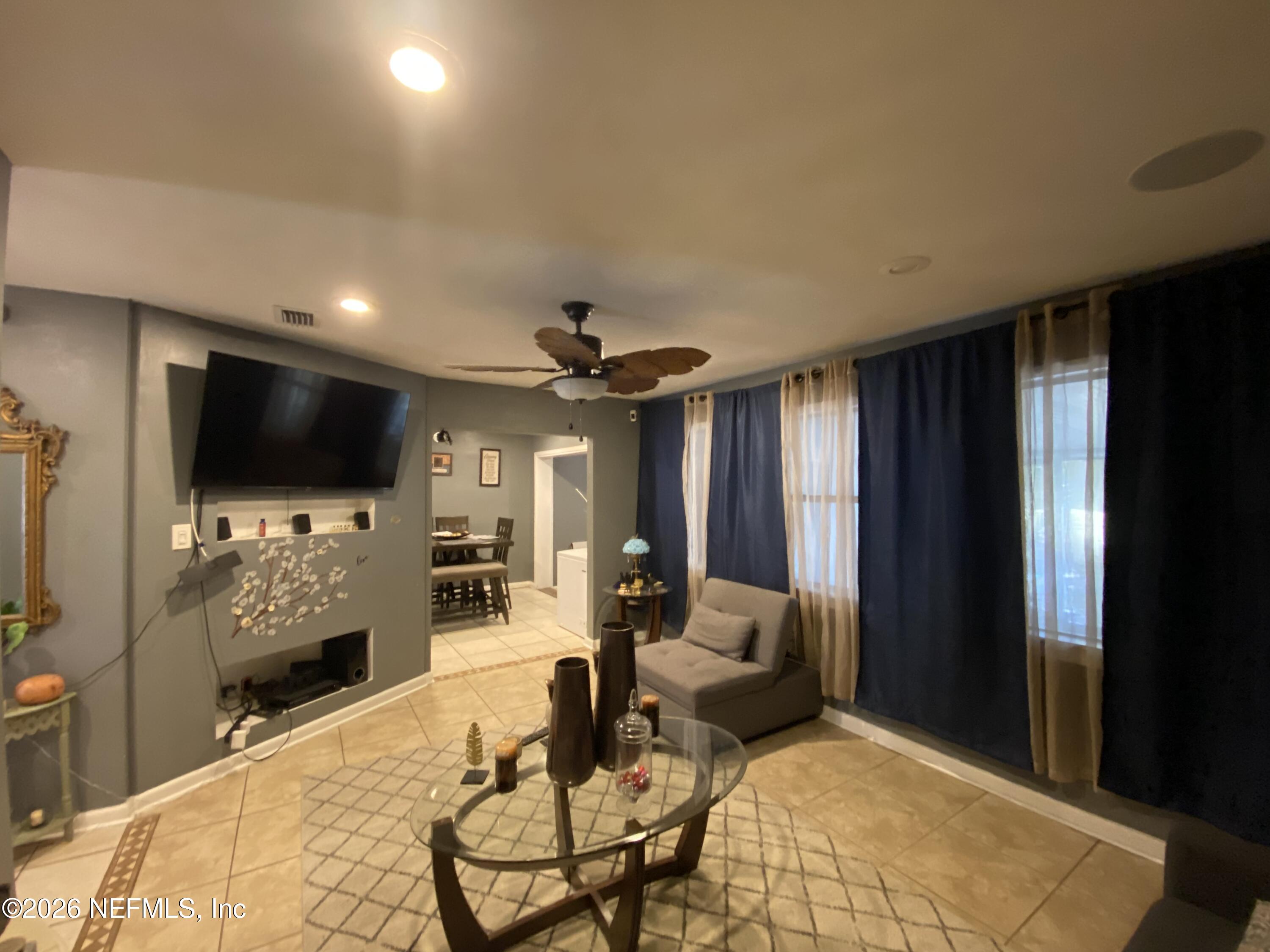 6400 Diane Road Jacksonville, FL 32277 - Photo 2 of 16 a living room with furniture and a flat screen tv