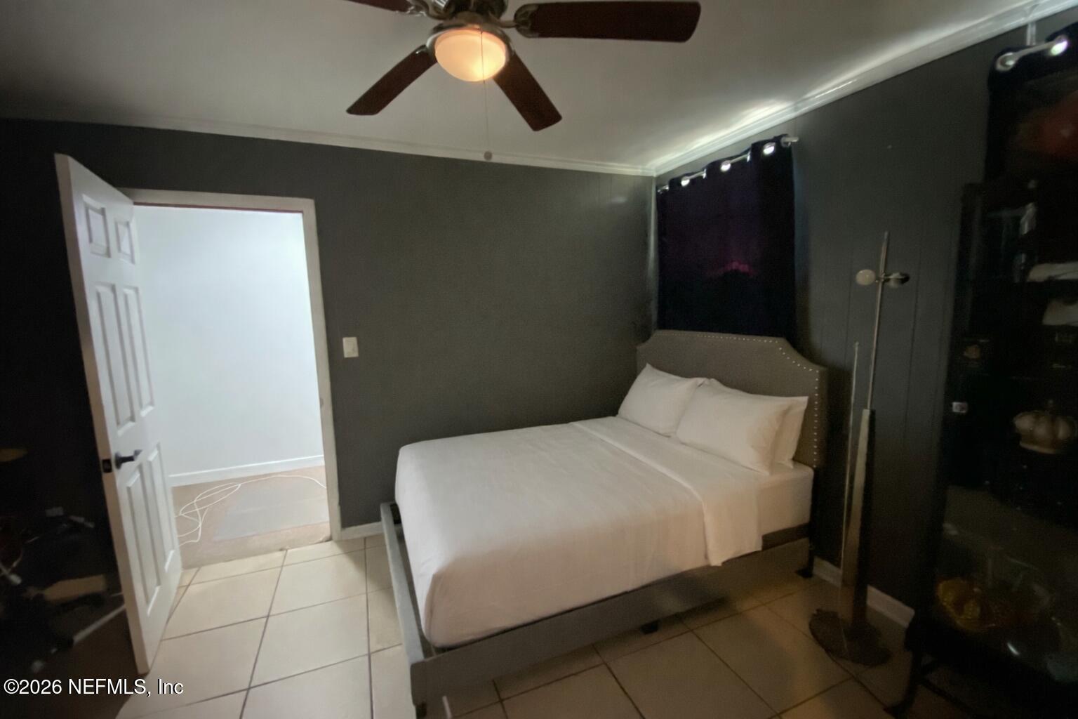 6400 Diane Road Jacksonville, FL 32277 - Photo 6 of 16 a bedroom with a bed and a chandelier