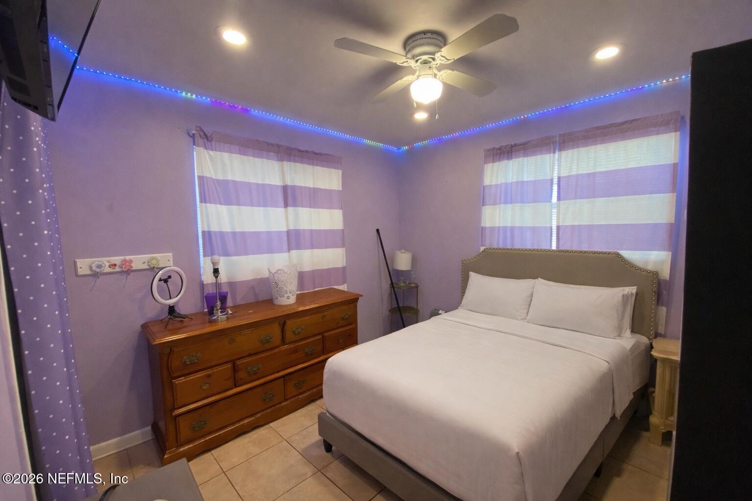 6400 Diane Road Jacksonville, FL 32277 - Photo 8 of 16 a bedroom with a bed and a chandelier