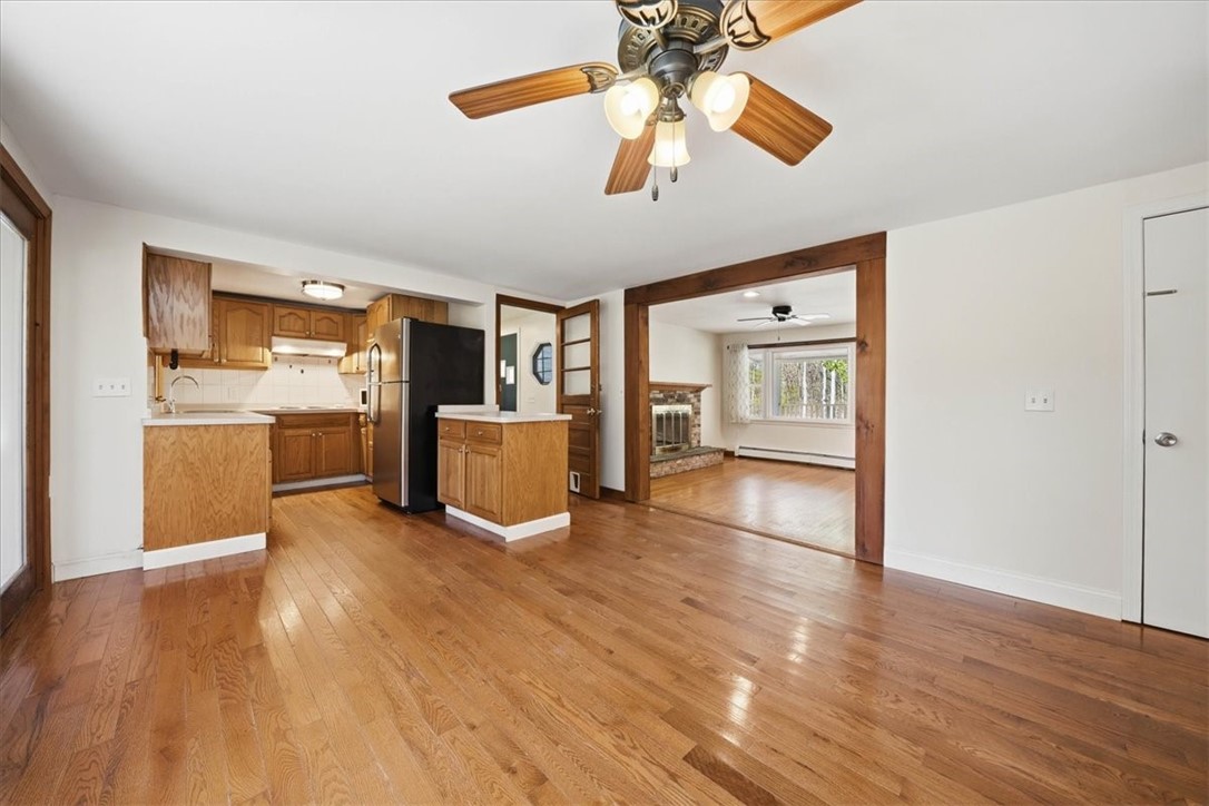 322 Rocky Hill Road Scituate, RI 02857 - Photo 19 of 50 Positioned just off the kitchen and adjacent to the main living room, this space offers versatility for formal dining, casual meals, or even an additional sitting area.