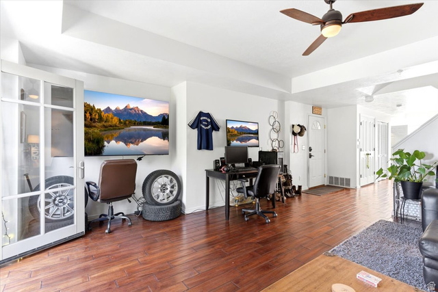 161 25th Street, Unit 6B Ogden, UT 84401 - Photo 3 of 20 Spacious living area featuring wood-finish flooring, white walls, and a ceiling fan with integrated lighting