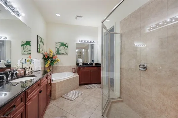 a bathroom with a double sink shower and a mirror