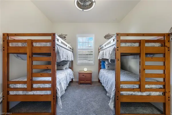 a bedroom with two bunk beds and a window