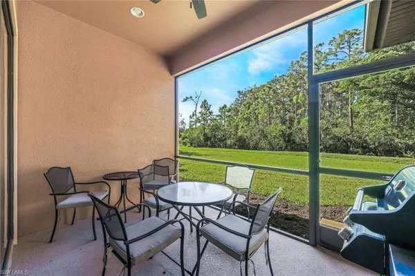 a view of a chairs and table in patio with a yard