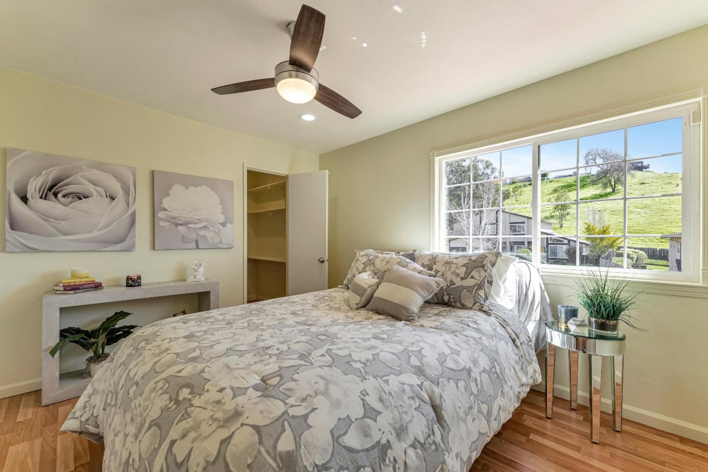 175 Violet Road Hercules, CA 94547 - Photo 11 of 35 a bedroom with a large bed and a chandelier