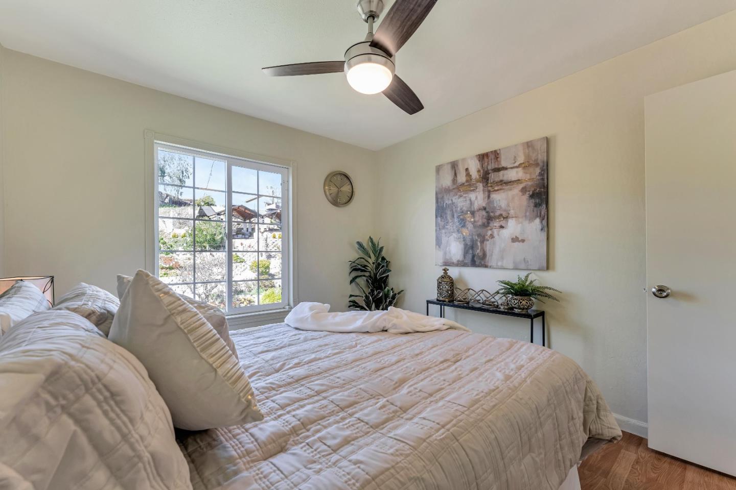 175 Violet Road Hercules, CA 94547 - Photo 12 of 35 a bedroom with a bed and a chandelier
