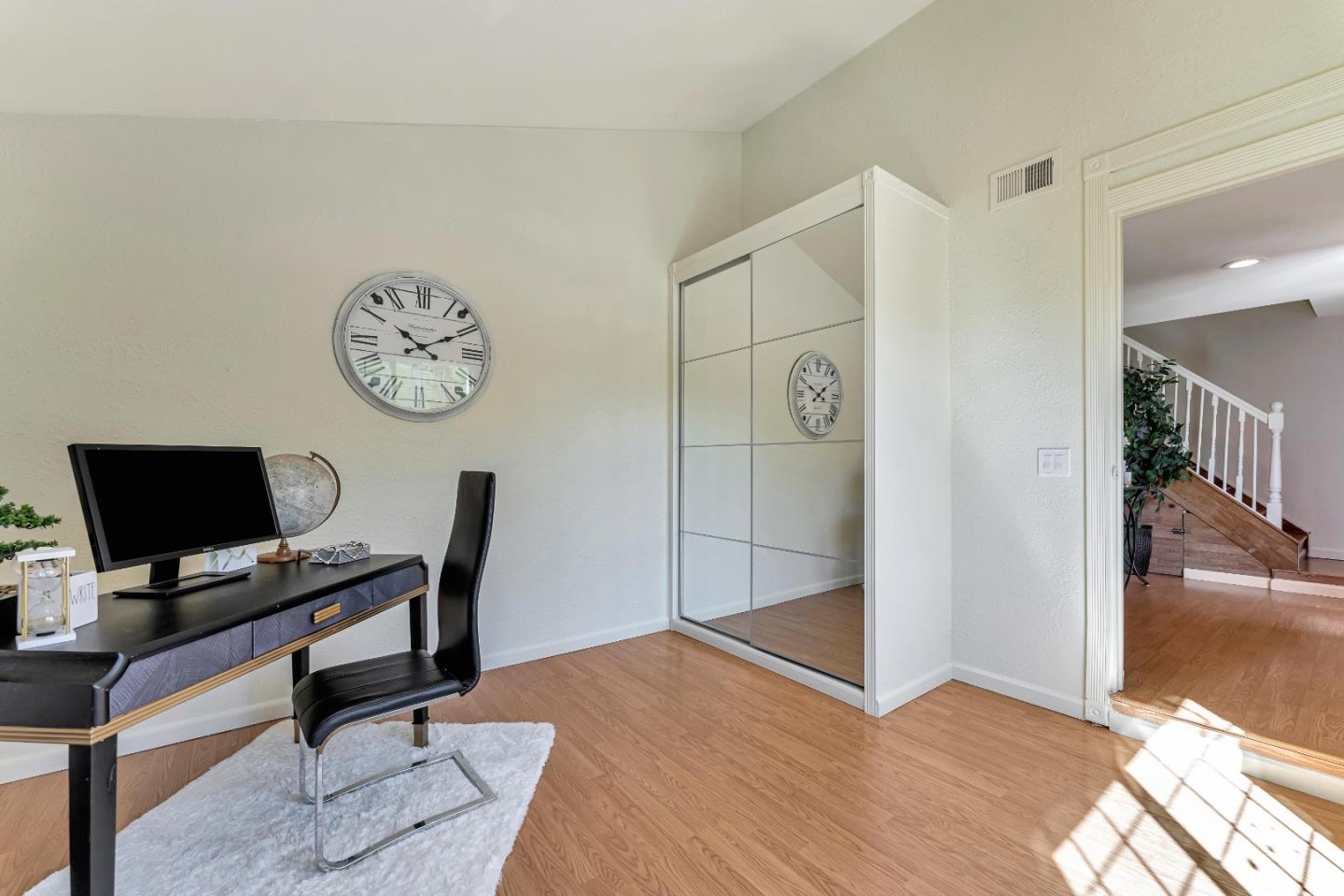 175 Violet Road Hercules, CA 94547 - Photo 17 of 35 a view of a workspace with a wooden floor and a chair