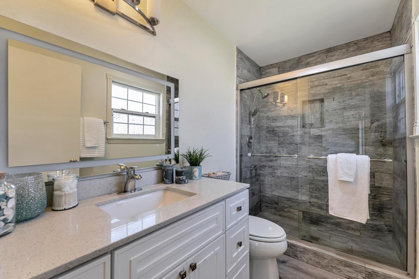 175 Violet Road Hercules, CA 94547 - Photo 8 of 35 a bathroom with a granite countertop sink a toilet a mirror and shower