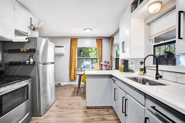 a kitchen with a sink appliances and cabinets