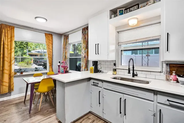 a kitchen with a sink stove and cabinets