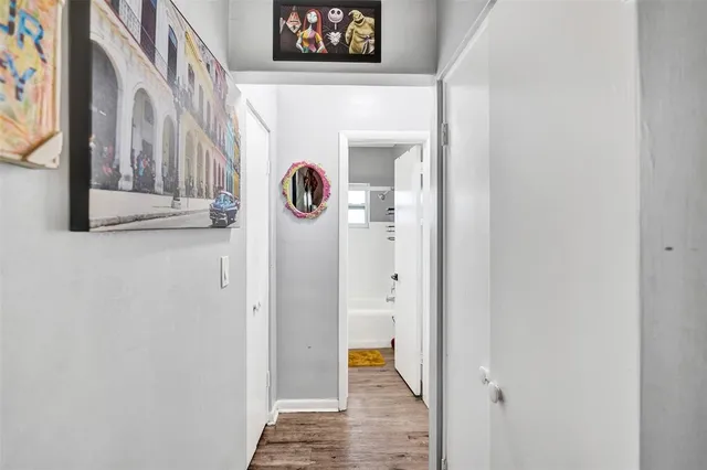 a view of a hallway with wooden door and stairs