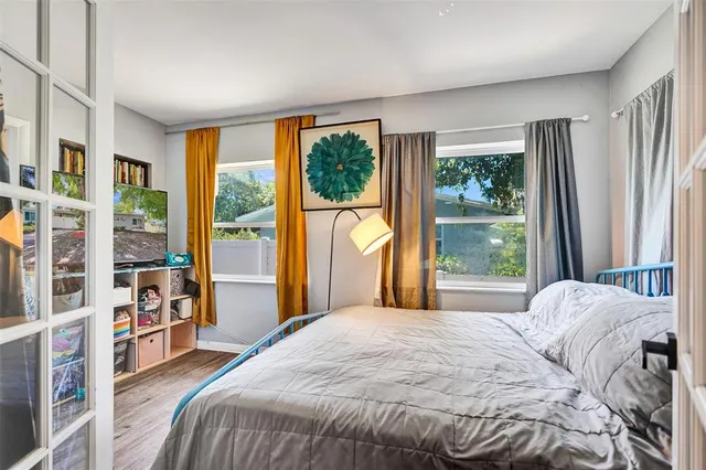 a bedroom with a large bed and a large window