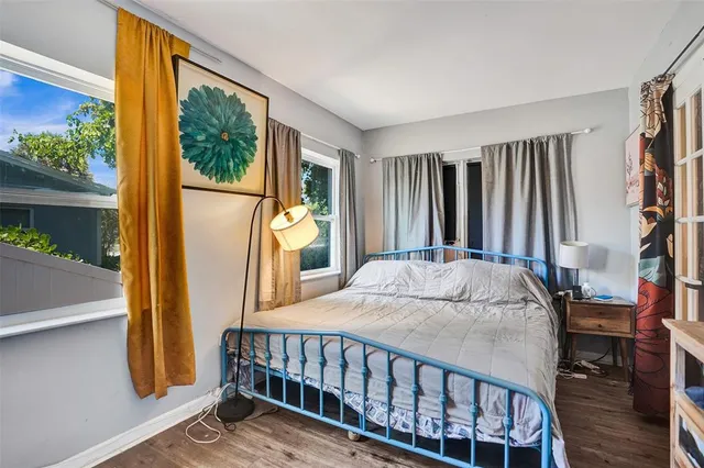 a bed sitting in a bedroom next to a window