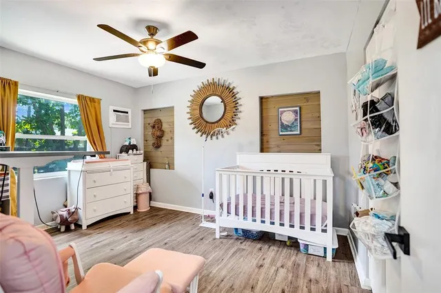 a view of a bedroom with furniture and windows