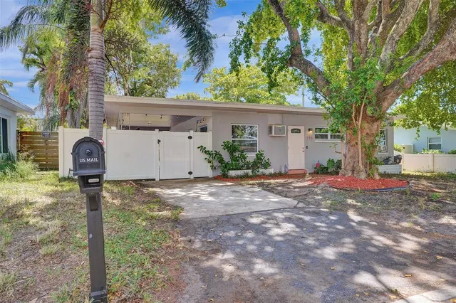 a backyard of a house with table and chairs