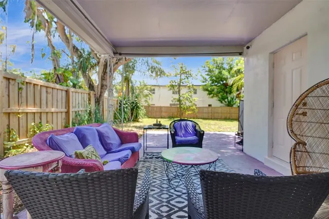 a living room with furniture floor to ceiling window and a table