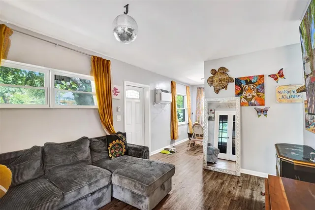 a living room with furniture fireplace and a large window