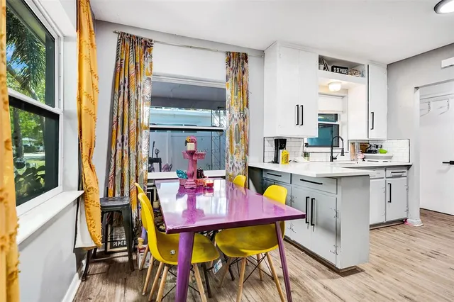 a view of a dining room with furniture and a window