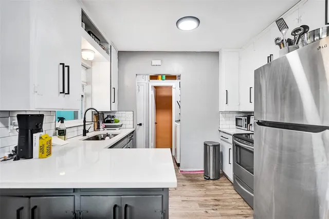 a kitchen with a refrigerator and a sink