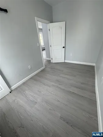 an empty room with wooden floor