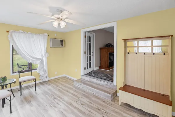 a view of a livingroom with wooden floor and a ceiling fan