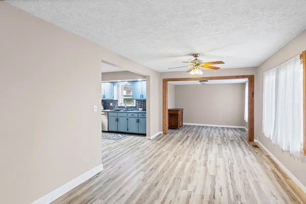 a view of a kitchen with a sink and dishwasher with wooden floor