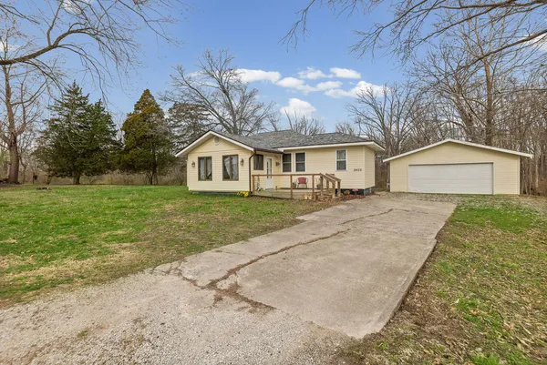 a view of house with a yard