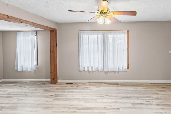 a large white kitchen with cabinets
