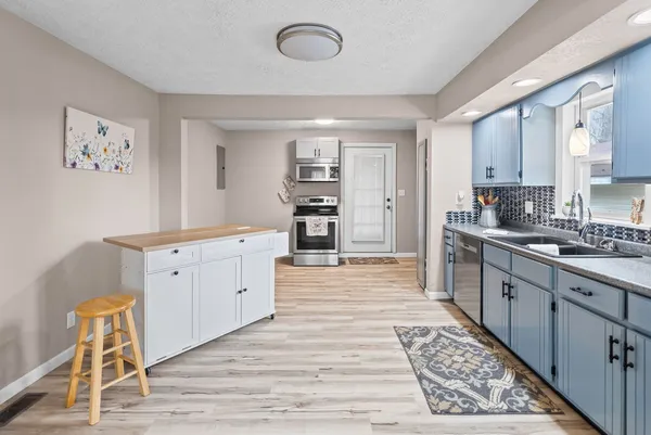 a kitchen with sink cabinets and window