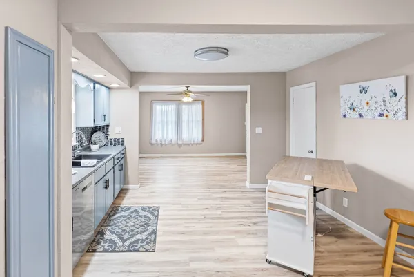 a view of room with a window and a ceiling fan